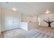 Bright and airy loft area featuring neutral carpet and white walls with a decorative tree mural at 4625 Walden Ct, Denver, CO 80249