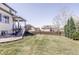 Spacious backyard with a well-maintained lawn, wooden fence, and a patio area, perfect for outdoor enjoyment at 7811 E 123Rd Ave, Thornton, CO 80602