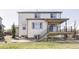 Exterior view of the home showcasing the deck, backyard, and patio, providing ample outdoor space at 7811 E 123Rd Ave, Thornton, CO 80602