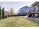 Large backyard featuring a deck, patio, and green lawn, offering plenty of space for outdoor activities at 7811 E 123Rd Ave, Thornton, CO 80602
