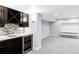 Finished basement featuring a bar with wooden cabinets and a tile backsplash, plus a rec room area at 7811 E 123Rd Ave, Thornton, CO 80602