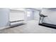 Finished basement featuring a modern, built-in media center and a treadmill for workouts at 7811 E 123Rd Ave, Thornton, CO 80602