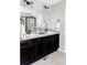 Elegant bathroom vanity featuring dual sinks, dark wood cabinets, and modern lighting at 7811 E 123Rd Ave, Thornton, CO 80602