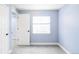 This bedroom features two white doors, a window with blinds, and neutral walls and carpet at 7811 E 123Rd Ave, Thornton, CO 80602