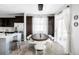 Elegant dining area with a modern light fixture, stylish chairs, and natural light at 7811 E 123Rd Ave, Thornton, CO 80602
