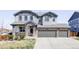 Beautiful two-story home with a three-car garage, stone accents, and well-maintained landscaping at 7811 E 123Rd Ave, Thornton, CO 80602