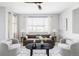 Cozy living room with neutral tones, comfortable seating, and a large window at 7811 E 123Rd Ave, Thornton, CO 80602