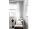 Comfortable sitting area in a bedroom with a cushioned chair, ottoman, and accent table at 7811 E 123Rd Ave, Thornton, CO 80602
