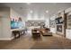 Spacious basement featuring a cozy sitting area, shuffleboard table, and entertainment center, perfect for relaxation at 1042 Country Club Estates Dr, Castle Rock, CO 80108