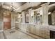 Elegant bathroom with dual vanities, decorative lighting, and ample storage space with drawers at 1042 Country Club Estates Dr, Castle Rock, CO 80108