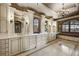 Luxurious bathroom with double vanities, marble countertops, decorative mirrors, and a soaking tub under a chandelier at 1042 Country Club Estates Dr, Castle Rock, CO 80108