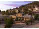Beautiful stone home nestled in a wooded area with multiple stories, and surrounded by trees at 1042 Country Club Estates Dr, Castle Rock, CO 80108