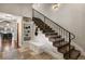 Inviting foyer features stylish tile flooring, staircase, and charming built-in shelving with decorative accents at 1042 Country Club Estates Dr, Castle Rock, CO 80108