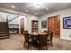 A basement game room with poker table and chairs, sports memorabilia, and a staircase at 1042 Country Club Estates Dr, Castle Rock, CO 80108