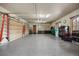 A spacious three-car garage with epoxy floors and tool storage and organization at 1042 Country Club Estates Dr, Castle Rock, CO 80108