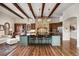 Elegant kitchen with a large island, pendant lighting, stone accents, and hardwood floors at 1042 Country Club Estates Dr, Castle Rock, CO 80108