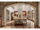 Spacious living area with hardwood floors, stone archway, and cozy seating arrangement at 1042 Country Club Estates Dr, Castle Rock, CO 80108