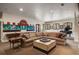 A cozy living room features a large sectional sofa, a coffee table, and a mural on the wall at 1042 Country Club Estates Dr, Castle Rock, CO 80108