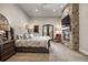 Comfortable main bedroom featuring a fireplace, stone accent wall, and private access to a balcony at 1042 Country Club Estates Dr, Castle Rock, CO 80108