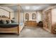 A spacious main bedroom featuring a four-poster bed, arched windows, and a decorative armoire at 1042 Country Club Estates Dr, Castle Rock, CO 80108