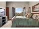 Comfortable main bedroom boasts an open balcony and beautiful views with elegant furnishings and serene ambiance at 1042 Country Club Estates Dr, Castle Rock, CO 80108