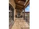 Beautiful patio with stone fireplace, tv, ceiling fans, and outdoor seating area for relaxing and entertaining at 1042 Country Club Estates Dr, Castle Rock, CO 80108