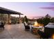 Gorgeous outdoor patio with pergola, fire pit, and comfortable seating, perfect for entertaining and enjoying the evening sky at 1042 Country Club Estates Dr, Castle Rock, CO 80108