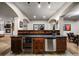 Beautiful wet bar featuring custom cabinetry, a wine fridge, and a convenient sink, perfect for entertaining guests at 1042 Country Club Estates Dr, Castle Rock, CO 80108