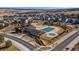 Aerial view of community clubhouse and pool surrounded by a neighborhood at 18130 Bolero Dr, Parker, CO 80134