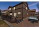 Stunning backyard view with a wooden deck, hot tub, and beautifully landscaped surroundings, perfect for relaxation at 18130 Bolero Dr, Parker, CO 80134