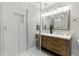 Bathroom featuring a glass shower and a double sink vanity with a neutral color palette at 18130 Bolero Dr, Parker, CO 80134