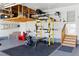 Well-organized garage featuring ample storage, a work-out area, and space for parking and projects at 18130 Bolero Dr, Parker, CO 80134