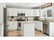A spacious kitchen with granite countertops, stainless steel appliances, and white cabinets at 18130 Bolero Dr, Parker, CO 80134