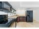 Efficient kitchen featuring dark appliances, wood cabinets and tile backsplash at 18130 Bolero Dr, Parker, CO 80134