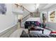 Bright living room with a staircase, featuring modern flooring and an open layout for entertaining at 18130 Bolero Dr, Parker, CO 80134