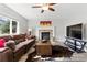 Inviting living room featuring a brick fireplace, comfortable seating, and a large window at 18130 Bolero Dr, Parker, CO 80134