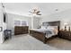 A spacious main bedroom featuring neutral colors, a ceiling fan, carpet and a window at 18130 Bolero Dr, Parker, CO 80134