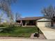 Attractive single-story house boasts a lush green lawn, front porch, and a neutral exterior at 10566 Canosa Ct, Denver, CO 80234