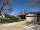 Charming single-story home features a well-manicured lawn, covered porch, and attached two-car garage at 10566 Canosa Ct, Denver, CO 80234