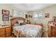 Cozy bedroom with a wooden headboard bed, a dresser, and multiple wall decorations at 518 Cherry St, Hudson, CO 80642