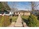 Charming brick home with a well-maintained lawn and inviting front porch seating area at 518 Cherry St, Hudson, CO 80642
