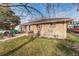Tan brick house featuring a charming front yard and porch, creating a welcoming entrance at 518 Cherry St, Hudson, CO 80642