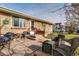 Charming brick home with a cozy patio area and seating, perfect for outdoor living at 518 Cherry St, Hudson, CO 80642