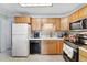 Functional kitchen featuring ample cabinet space, modern appliances, and neutral tiled flooring at 518 Cherry St, Hudson, CO 80642