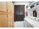Well-organized laundry room with washer, dryer, cabinet, and storage shelves for cleaning supplies at 518 Cherry St, Hudson, CO 80642