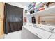 A well maintained laundry room with washer, dryer, storage shelves, and a hanging rack at 518 Cherry St, Hudson, CO 80642