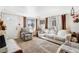 Cozy living room featuring neutral tones, comfortable seating, and ample natural light from the windows at 518 Cherry St, Hudson, CO 80642