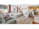 Bright living room with a plush sofa, a view into the kitchen, and decorative accents at 518 Cherry St, Hudson, CO 80642