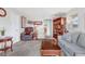 Spacious living room with neutral carpet, comfortable seating, and a decorative display cabinet at 518 Cherry St, Hudson, CO 80642