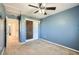 A blue bedroom with a ceiling fan and closet at 2228 Gold Dust Trl, Highlands Ranch, CO 80129